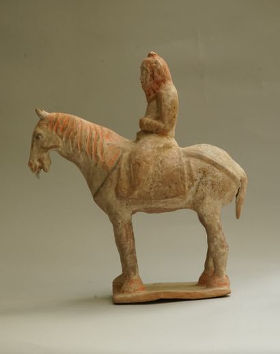 A beige terracotta warrior on horseback with...