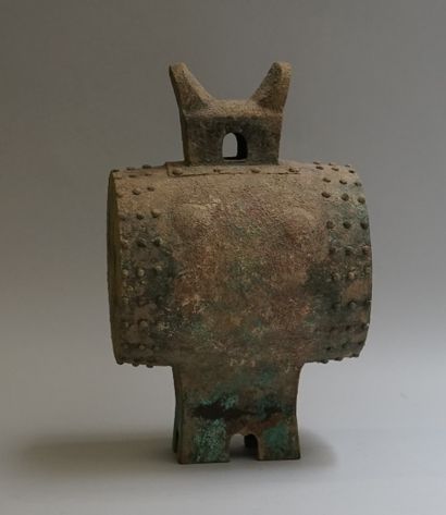 Copper drum resting on a quadripod base and...