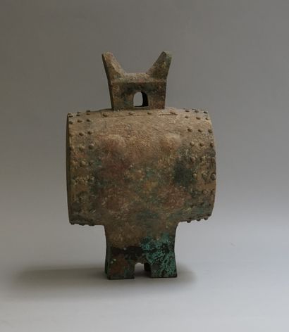 Copper drum resting on a quadripod base and...