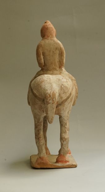 A beige terracotta warrior on horseback with...