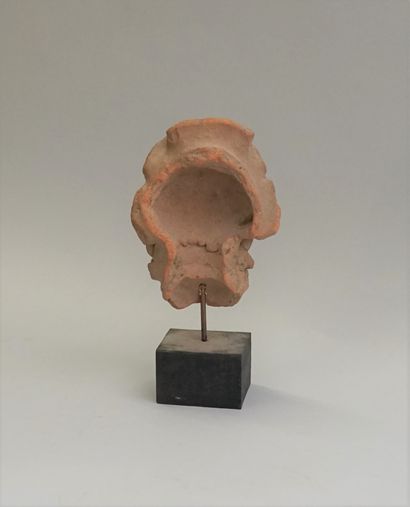 Head in pinkish terracotta represented with...