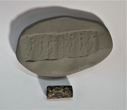 Black hardstone cylinder seal with a parade...