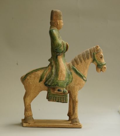 A beige earthenware musician on horseback...