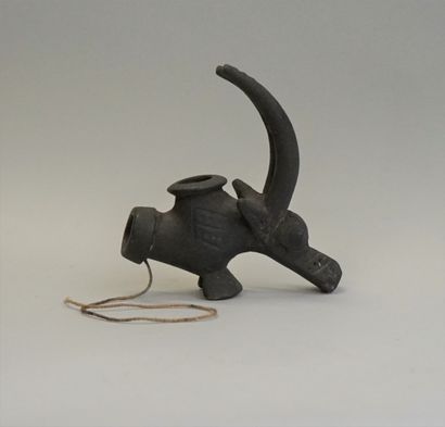 Old brown clay pipe stove in the shape of...