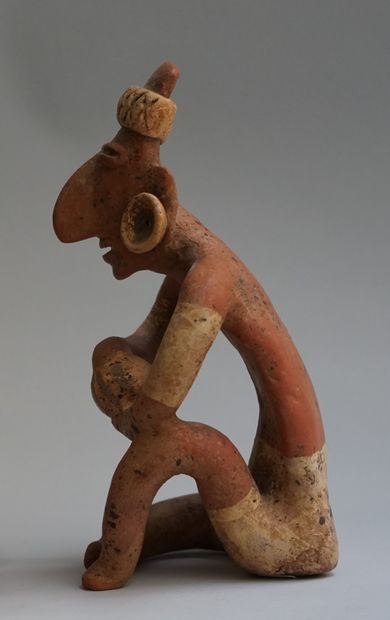 Anthropomorphic sculpture presenting a seated...