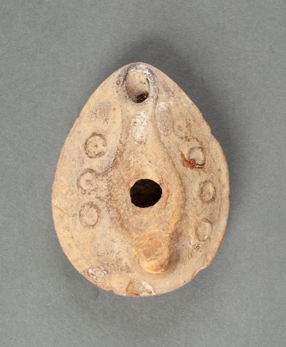 Beige terracotta oil lamp with circles decoration...