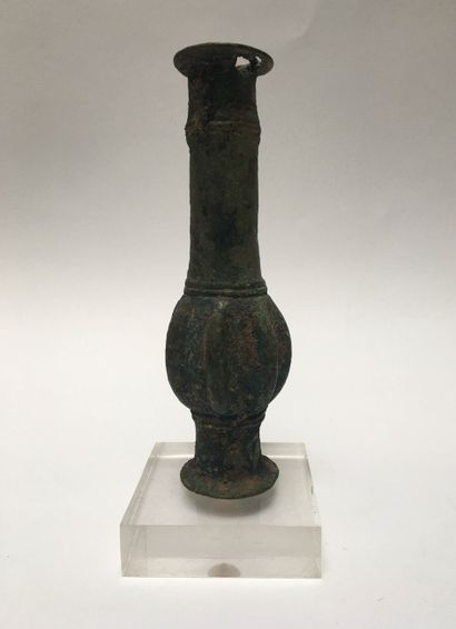 Bronze weapon mass with green patina. The...