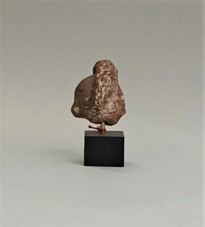 Red terracotta head wearing an imposing headdress...