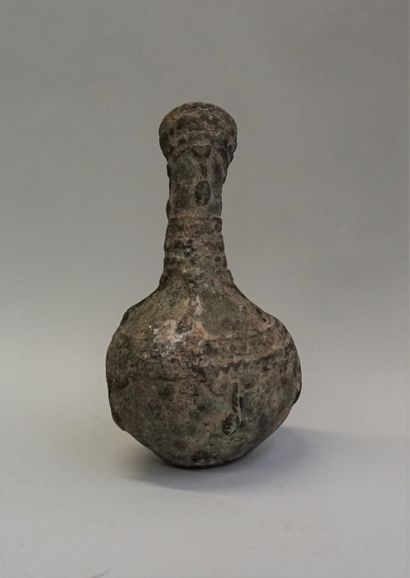 Bronze libation vase with curved neck, decorated...