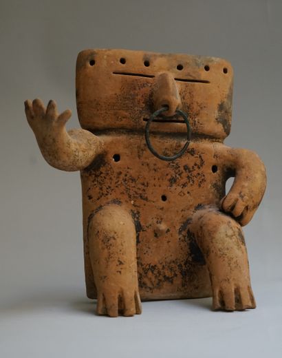 Anthropomorphic statuette showing a seated...