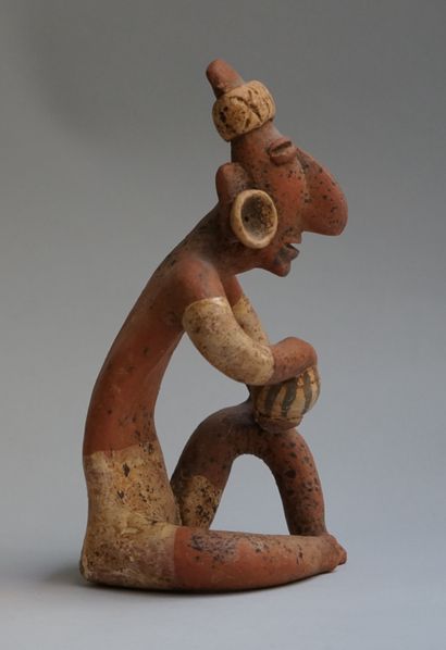 Anthropomorphic sculpture presenting a seated...