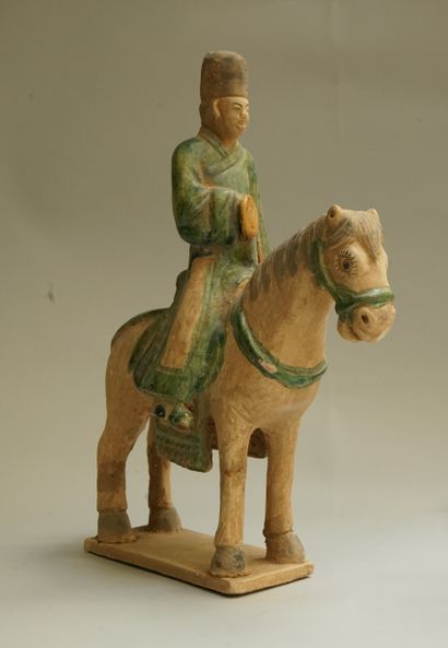 A beige earthenware musician on horseback...