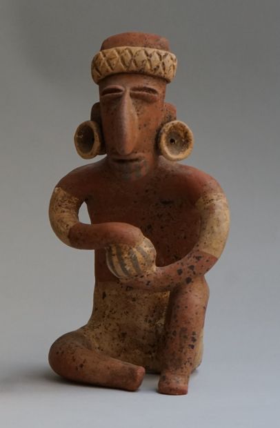 Anthropomorphic sculpture presenting a seated...