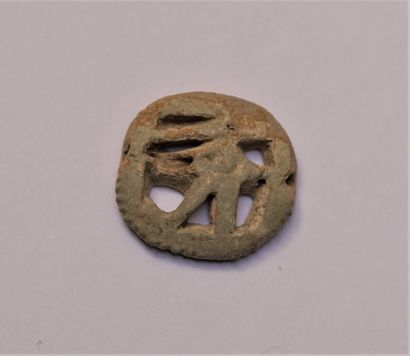 Green enamelled frit amulet representing...