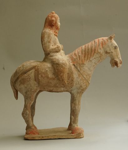 A beige terracotta warrior on horseback with...
