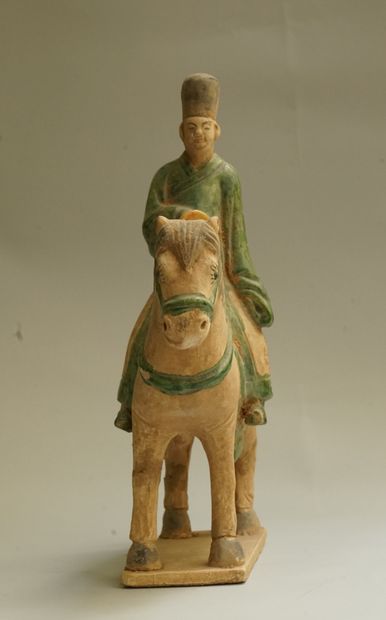 A beige earthenware musician on horseback...