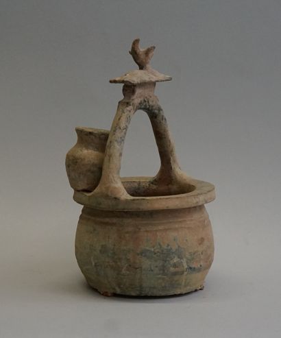 Representation of a well with a jug and topped...