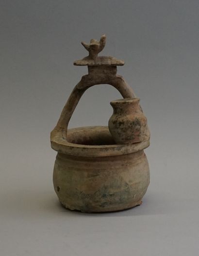 Representation of a well with a jug and topped...