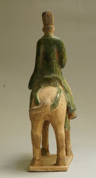 A beige earthenware musician on horseback...