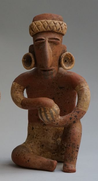 Anthropomorphic sculpture presenting a seated...