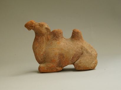 Small orange-beige terracotta reclining camel....