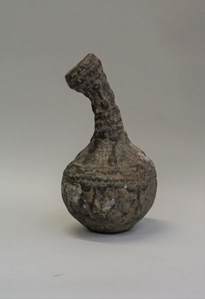 Bronze libation vase with curved neck, decorated...
