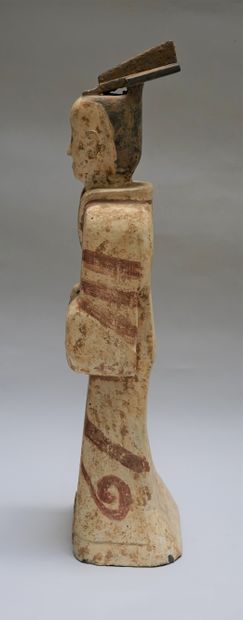 Standing terracotta figure with white, black...