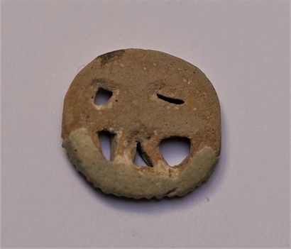 Green enamelled frit amulet representing...