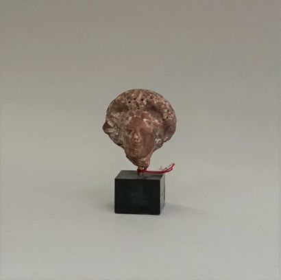 Red terracotta head wearing an imposing headdress...