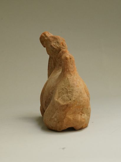 Small orange-beige terracotta reclining camel....
