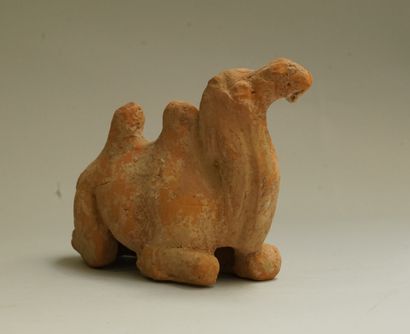 Small orange-beige terracotta reclining camel....