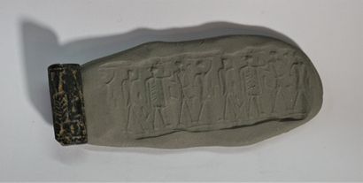 A black hardstone cylinder seal decorated...