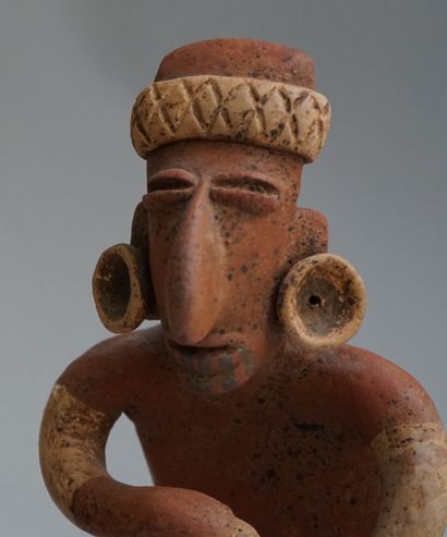 Anthropomorphic sculpture presenting a seated...