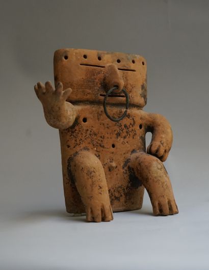 Anthropomorphic statuette showing a seated...