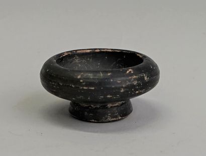 Black glazed terracotta bowl on pedestal.

Gnatia,...