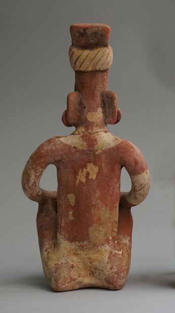Anthropomorphic sculpture of a seated figure...