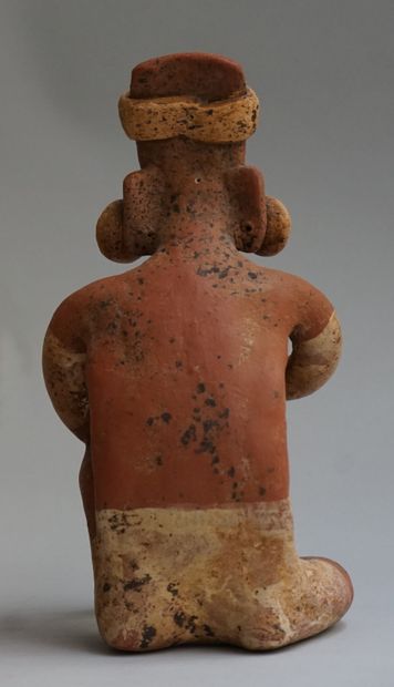 Anthropomorphic sculpture presenting a seated...
