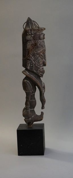 End of a sceptre in the shape of a figure....