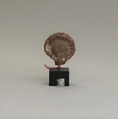 Red terracotta head wearing an imposing headdress...