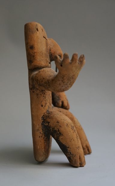 Anthropomorphic statuette showing a seated...