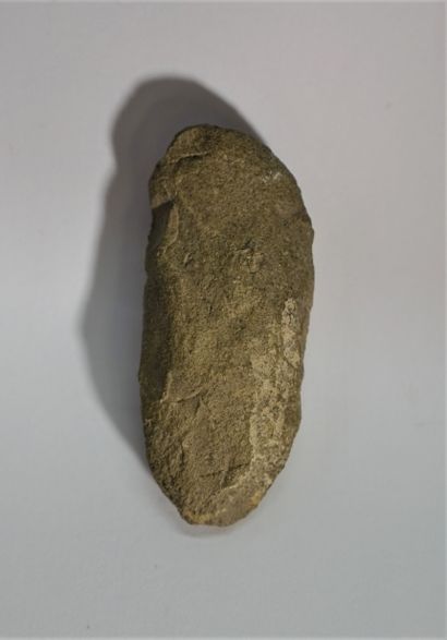 Grey stone fragment showing a figure holding...