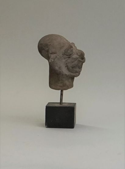 Jaguar head in grey terracotta. It has two...
