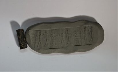 Black hardstone cylinder seal depicting a...