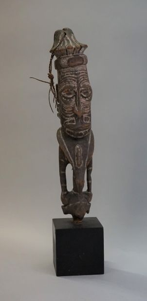 End of a sceptre in the shape of a figure....