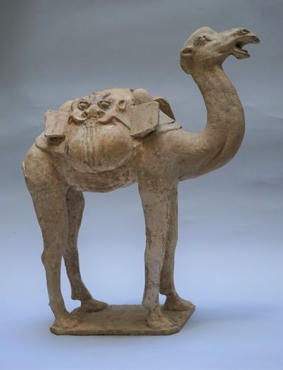 A beige terracotta camel with white polychrome...