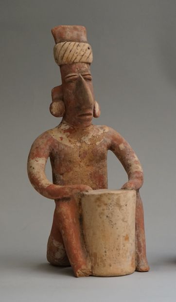 Anthropomorphic sculpture of a seated figure...