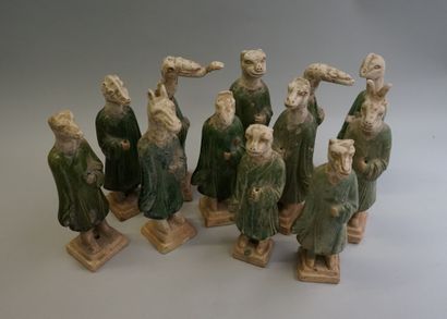 Twelve figures of a procession with heads...