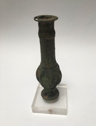 Bronze weapon mass with green patina. The...