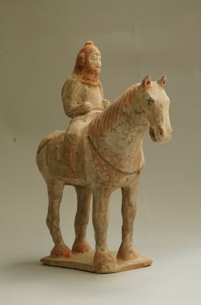 A beige terracotta warrior on horseback with...