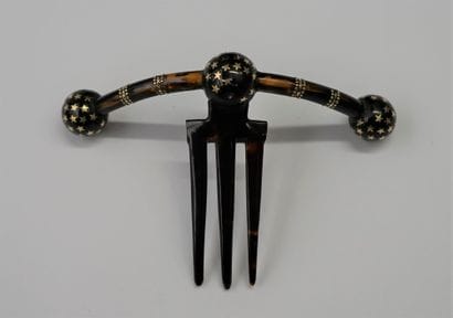 Three-pronged brown tortoiseshell comb, the...